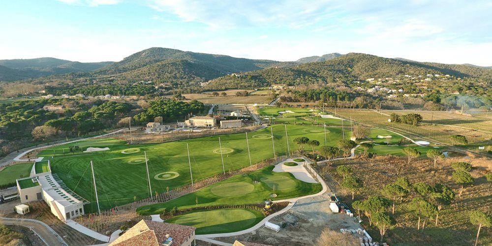 Oakley Aerial view of a synthetic grass golf course surrounded by hills