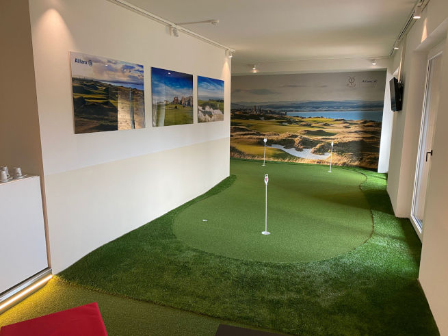 Oakley indoor putting green in an office with scenic wall art
